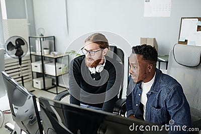 Two young intercultural diversity programmers looking at compute screen Stock Photo