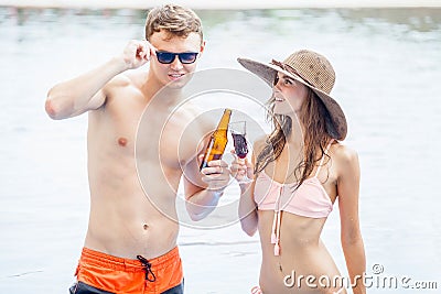 Two young making party in the pool and Drinking beverage with i Stock Photo