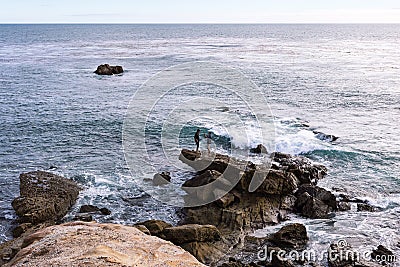 Two young men taking cell phone photos by the ocean Editorial Stock Photo