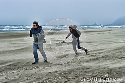 Two young men on a windy beach Stock Photo