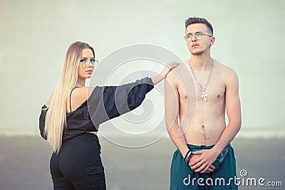 Two young people posing outside in street style clothes Stock Photo