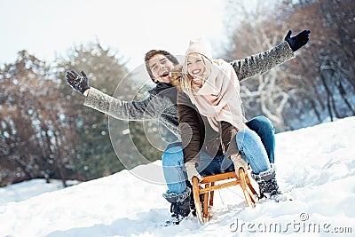 Two young people sliding on a sled Stock Photo