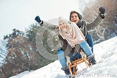 Two young people sliding on a sled Stock Photo