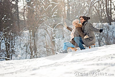 Two young people sliding on a sled Stock Photo