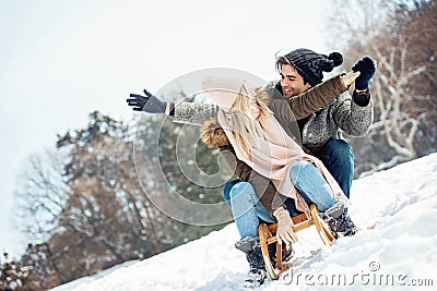 Two young people sliding on a sled Stock Photo