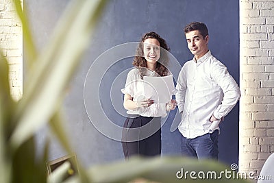 Two young professionals or students woman man happy with business meeting, smiling and talking about project. Stock Photo