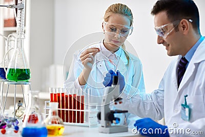 Two young scientists making an experiment in a laboratory Stock Photo