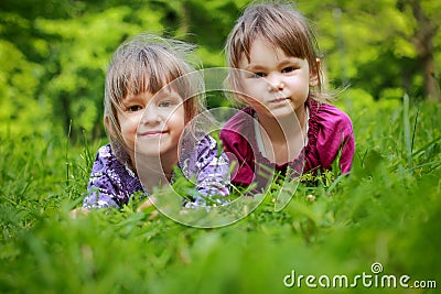 Two young smiling girls in the grass Stock Photo