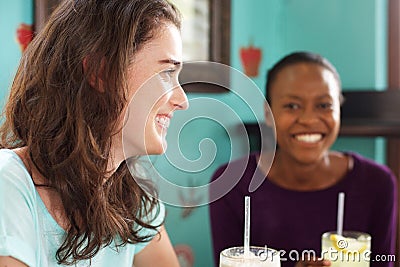 Two young smiling women at cafe Stock Photo