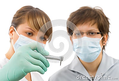 Two young sweet doctor examine the drill Stock Photo