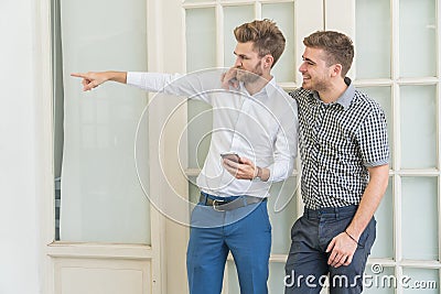 Young tourist man use their smartphone in hand direction and point in the way they wish to go Stock Photo