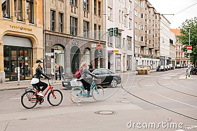 Berlin, October 2, 2017: Two young unknown girls riding bicycles along the street of Berlin Editorial Stock Photo