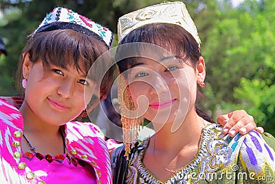 Two young Uzbek women traditionally dressed posing inside the Bakhautdin Naqshband mausoleum near Bukhara Editorial Stock Photo