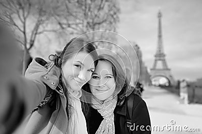 Two young woman taking a selfie near the Eiffel tower Stock Photo