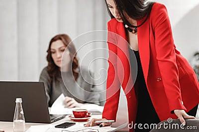 Two young women designer are working at the design project of interior at the desk with laptop and documentation in the Stock Photo