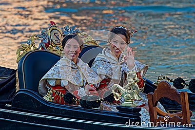 Two young women of the Festa delle Marie (Festival of the Mary) in theri gondola Editorial Stock Photo