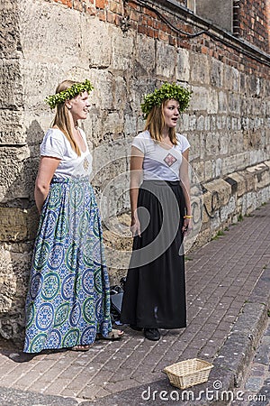 Two young women singing at street corner Riga Editorial Stock Photo