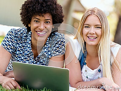 Two young women with tablet in park Stock Photo