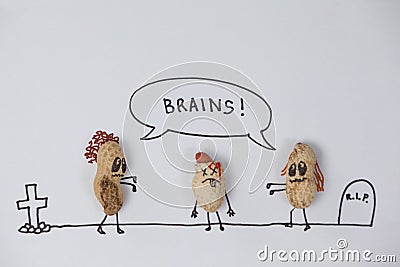 Two zombie figurines getting tempted towards the brain of broken head figurine Stock Photo