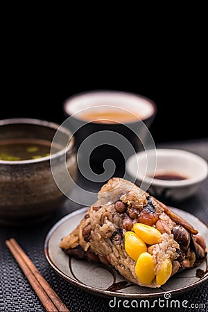 Two Zongzi or Asian Chinese sticky rice dumplings with isolated Stock Photo