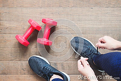 Tying sport shoes, Asian woman getting ready for weight training. Exercise, Fitness training. Healthy lifestyle Stock Photo