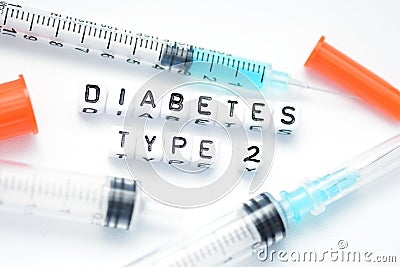 Type 2 diabetes text spelled with plastic letter beads placed next to an insulin syringe Stock Photo