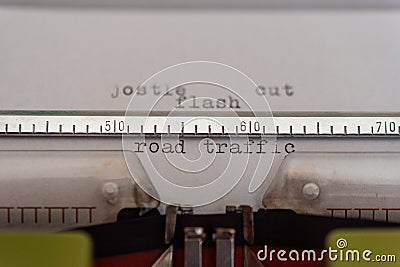 Typewriter with a leaf and the words jostle, cut, flash and road traffic Stock Photo