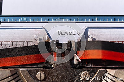 Typewriter with a sheet and the text Umwelt Environment Stock Photo