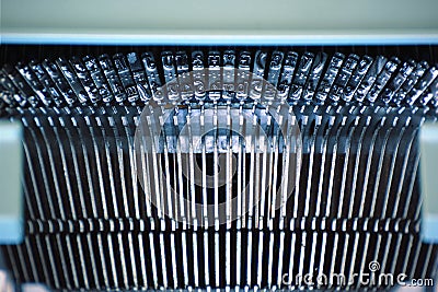 Typewriting machine detail. Metal letters forming a row. Stock Photo