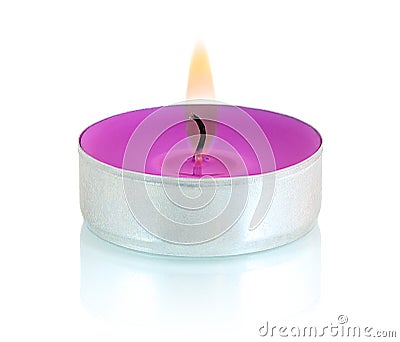 Typical aluminium burning purple tealight candle isolated on white background with shadow reflection. Stock Photo