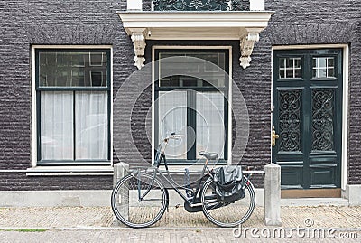 Typical Amsterdam street view in Netherlands with old doors and windows and vintage bicycle Stock Photo
