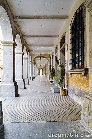 Typical arcades of old houses in the center of the city called B Stock Photo