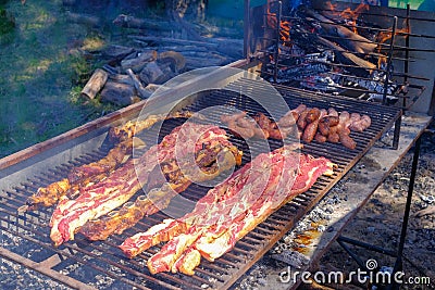 Typical argentinean asado parillada BBQ on a grill in Uruguay, also seen in Argentina, Brazil and Chile Stock Photo