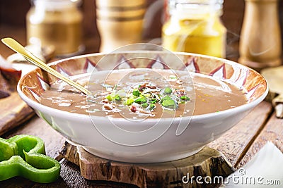 Typical Brazilian bean broth, bean soup with bacon, pepperoni, green aroma, onion and chopped vegetables Stock Photo