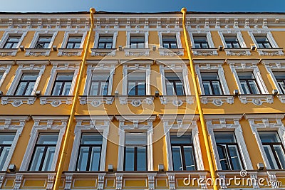 Typical building facade yellow and white color with windows in Saint-Petersburg on sunny day, Russia Stock Photo