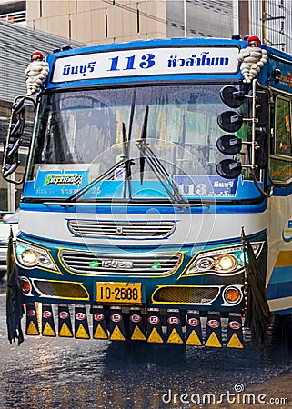 Typical colorful blue decorated bus in heavy rain Bangkok Thailand Editorial Stock Photo