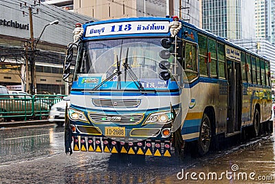 Typical colorful blue decorated bus in heavy rain Bangkok Thailand Editorial Stock Photo