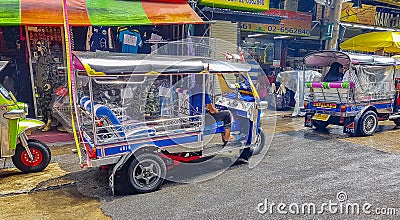 Typical colorful tuk tuks taxis driving people in Bangkok Thailand Editorial Stock Photo