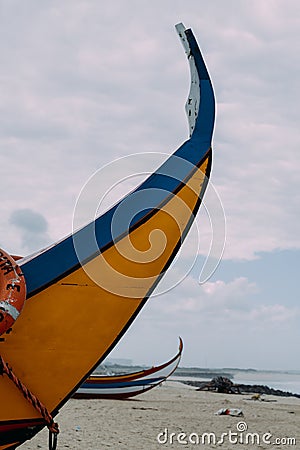 Typical colourful Moliceiro fishing boats on the beach in Espinho, Portugal Stock Photo