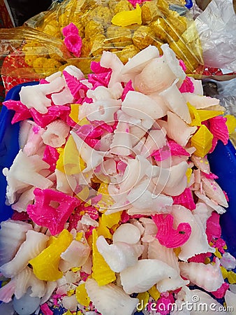 Typical colourful sweets of diwali made from cane sugar selling at kolkata footpath along with ladu. Stock Photo