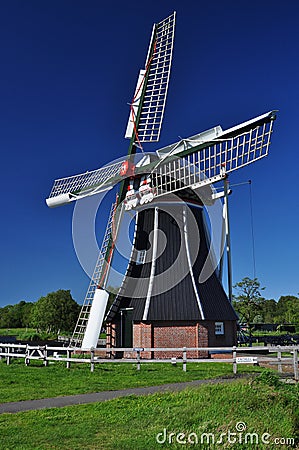 Typical Dutch windmill against a blue sky, Holland. Stock Photo