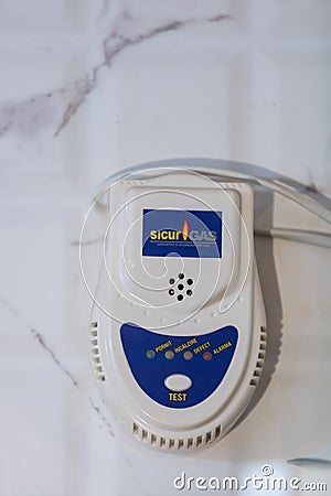 Typical gas sensor device on white tile. White gas detector device to prevent gas leaks and provide safety at home. Bucharest, Editorial Stock Photo