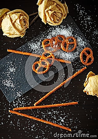 Typical German Bretzel. German food and snack. Delicious savory appetizer for lunch. Salted cracker bottom on slate bottom Stock Photo