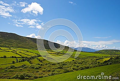 Typical green Irish country side with blue sky and cluds Stock Photo