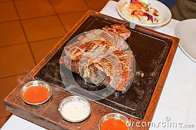 Typical grilled Bistecca Alla Fiorentina, T-Bone Porterhouse Steak, in an italian Restaurant, Florence, Tuscany, Italy Stock Photo