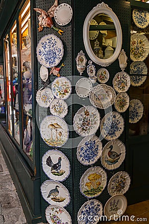 Typical handicraft product, hand painted plates hanging on the wall of a souvenir shop in Venice, Italy Editorial Stock Photo