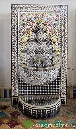Typical handmade moroccan mosaic fountain and vases in the courtyard of the Mosaic Factory Editorial Stock Photo