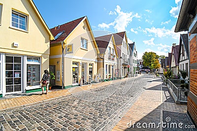 Typical historic picturesque street of shops and homes in the historic fishing village of Warnemunde Rostock Germany Editorial Stock Photo