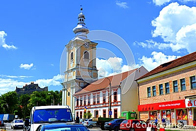 Typical houses. Medieval saxon church. Urban landscape in the city Rupea-Reps, Transylvania. Editorial Stock Photo