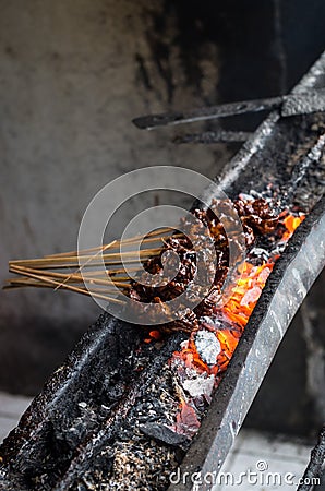 Typical Indonesian dish Sate ayam on local street market - vertical Stock Photo